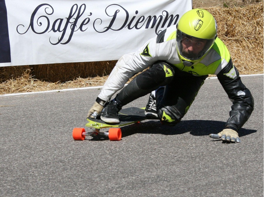 A professional longboarder with a full-face helmet