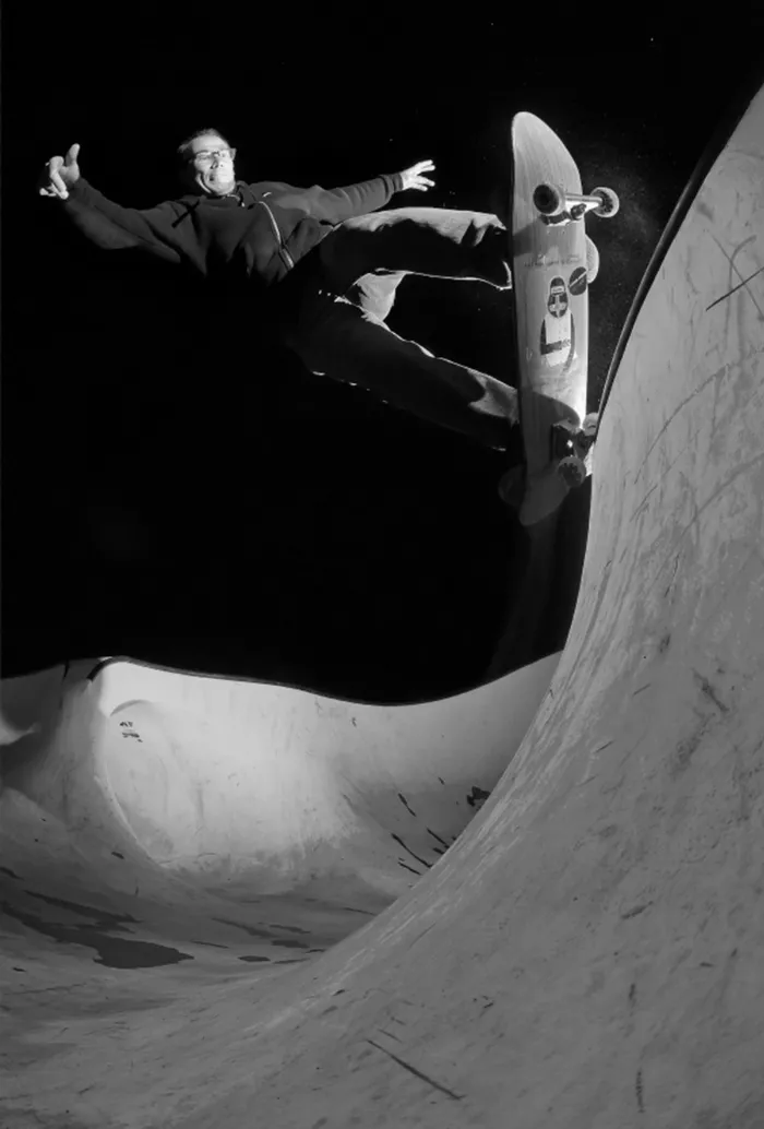 A black and white photo of Jeremie Daclin performing a slappy grind.