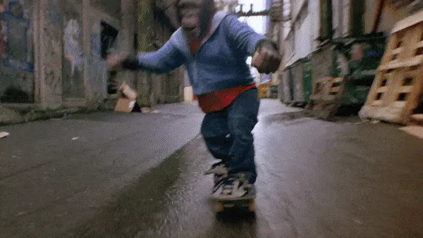 A chimp in a cut-out Etnies shoe on a skateboard