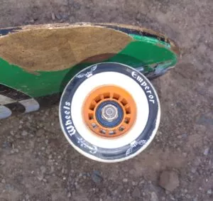 A close-up of a high-quality longboard wheel, showing its construction and urethane