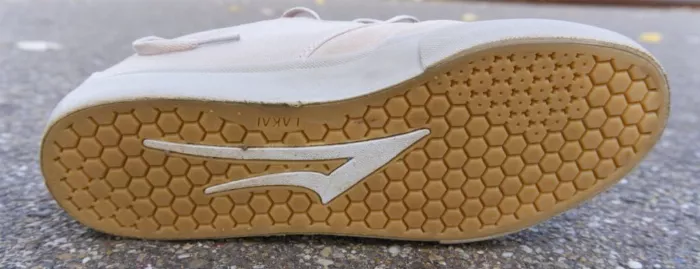 A close-up of a vulcanized shoe's outsole, highlighting the foxing tape