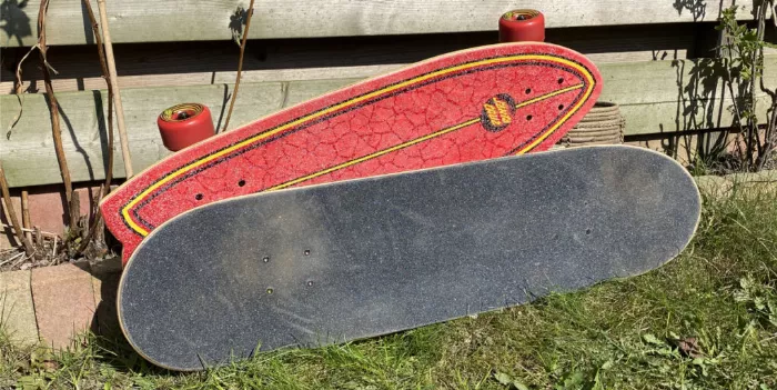 a cruiser and a skateboard next to eachother