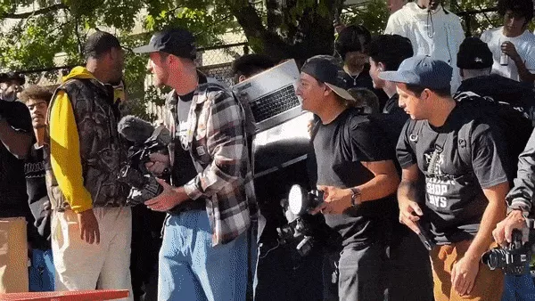 A GIF of a person skateboarding, filmed using a laptop with a fisheye lens