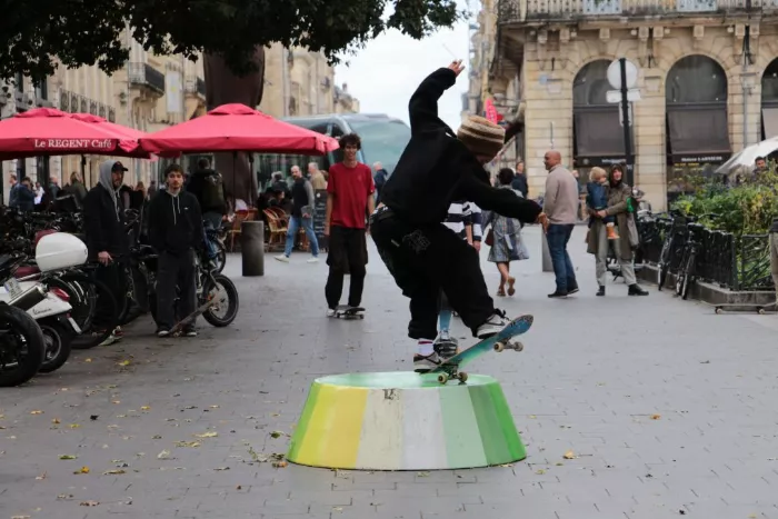 A ground-level perspective of a skater performing a trick in an urban environment