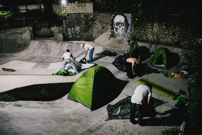 A group of longboarders and motorcyclists on a trip through the French countryside.