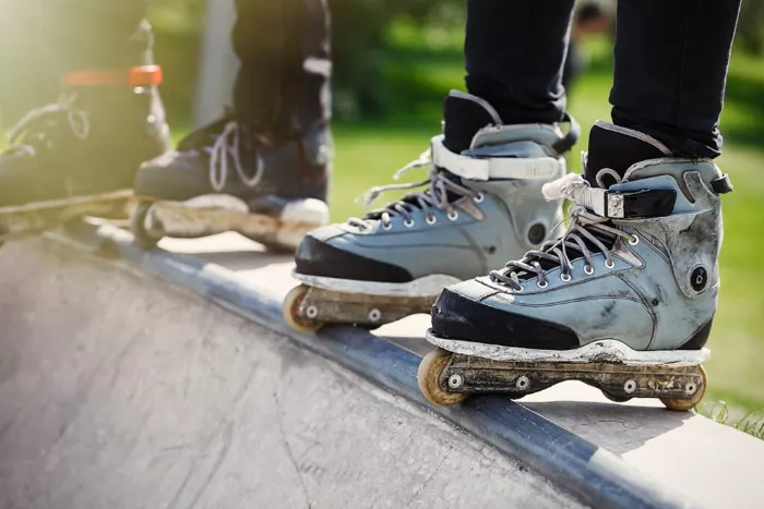 A group of rollerbladers in a skate park