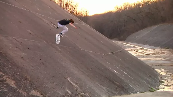 A group of skaters looking at a potential skate spot