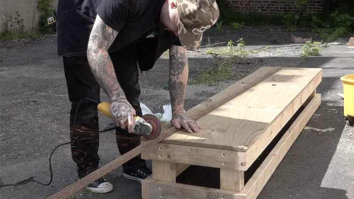 A group of skaters standing around the newly built skate box, ready to test it out.