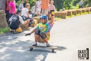 A half-shell helmet worn by a downhill skateboarder