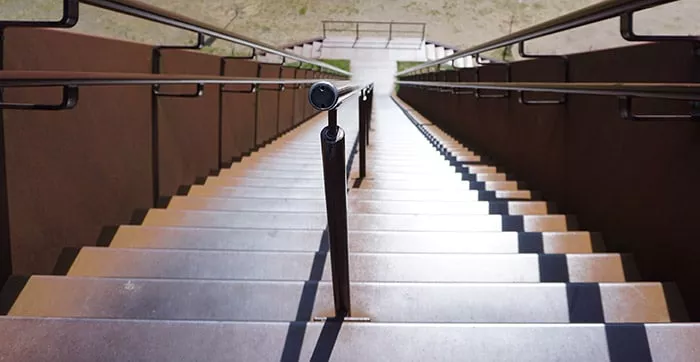 A longboarder practicing a trick on a rail, highlighting the risk and skill involved in advanced longboarding.