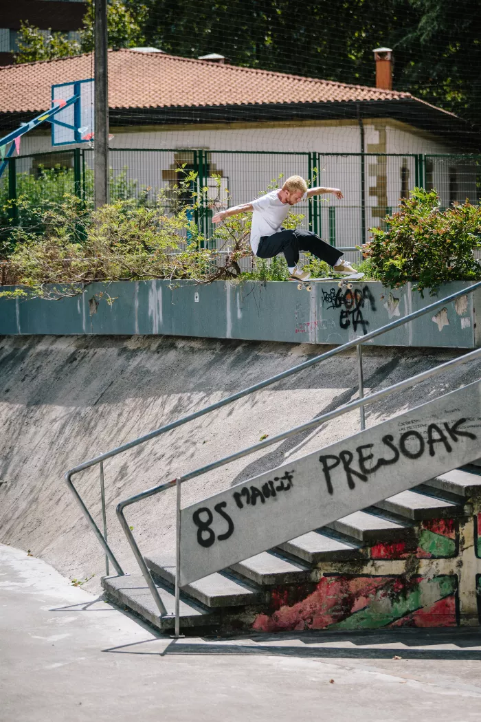 A longboarder pushing down a road, showcasing the simple joy of a ride in a rural setting.