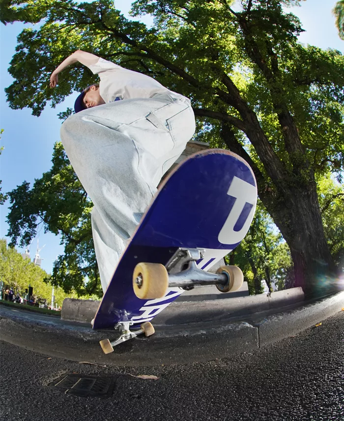 A person performs a slappy trick on a skateboard.