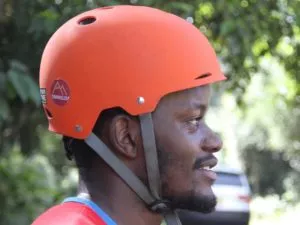 a person smiling while holding their skateboard, demonstrating the joy and mental well-being that skateboarding can bring