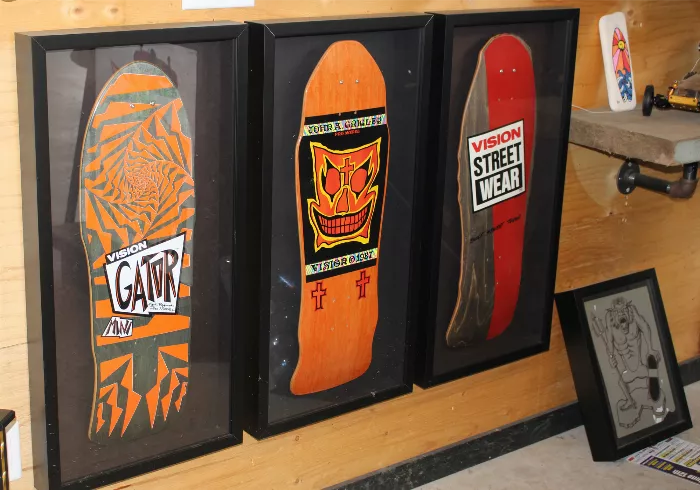 A photo of vintage cars and skateboard decks in a garage