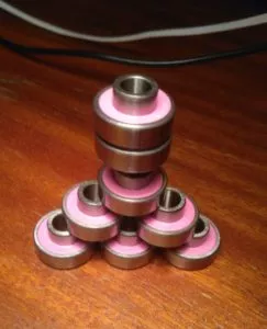 A pyramid of skateboard and longboard bearings, demonstrating different bearing types