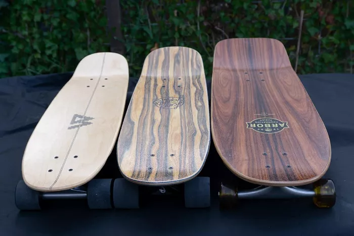 A selection of three mini-cruiser skateboards, showcasing their compact size and diverse designs.