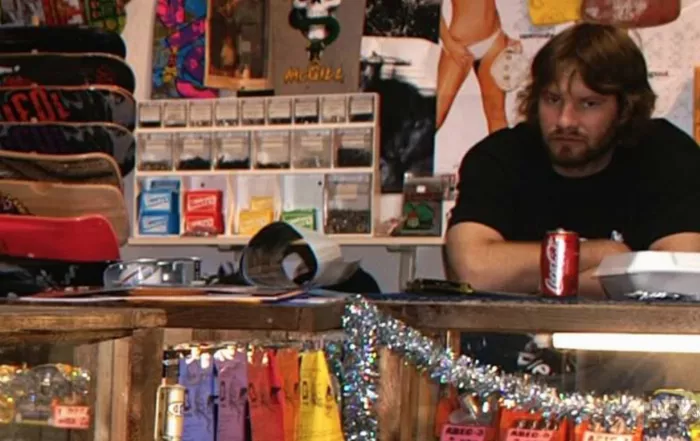 A skate shop employee looking stressed, possibly due to the demands of a shoe release.