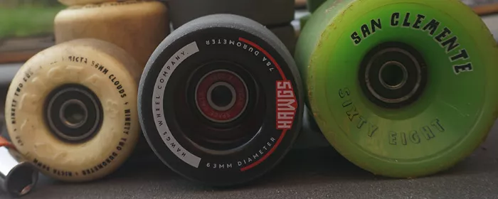 A skateboard with one hard wheel and one soft wheel