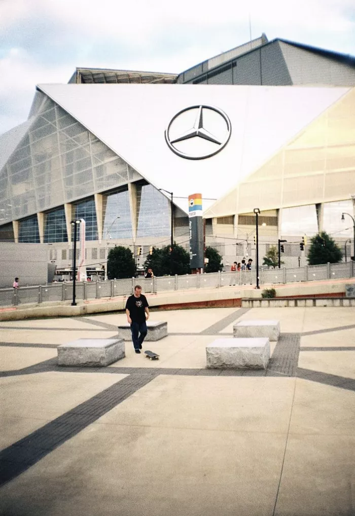 A skateboarder captured in a dynamic pose on the streets of Atlanta