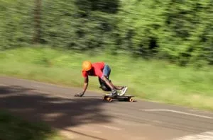 a skateboarder performing a toeside slide, showcasing the thrill of downhill skateboarding