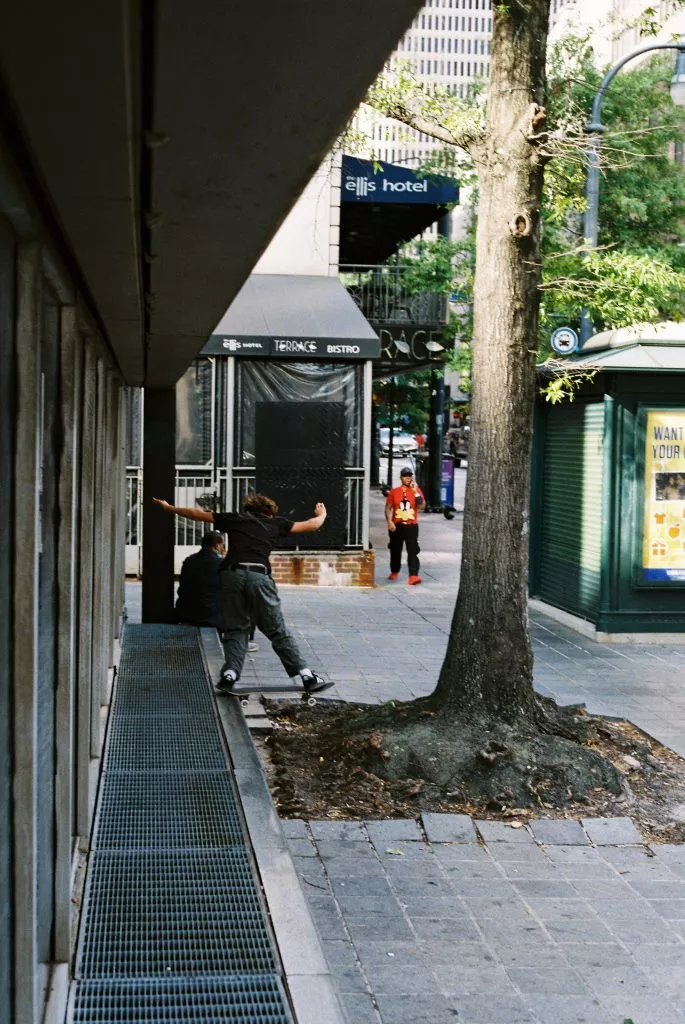 A skateboarder performing a trick at an urban skate spot