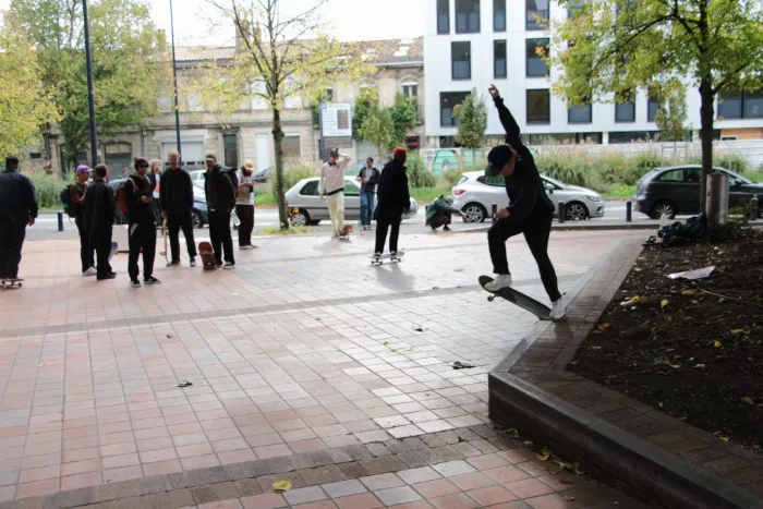 A skater grinding on a ledge in an urban setting