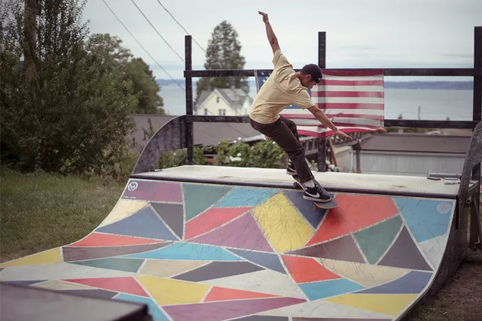 A skater performing a trick on a mini ramp