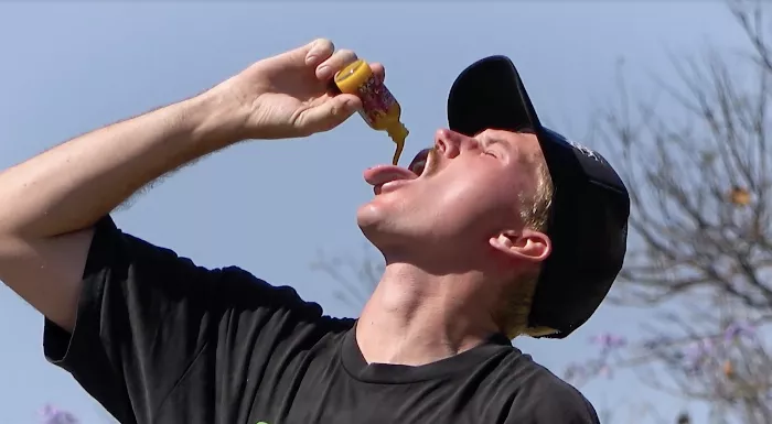 A skater skating with hot sauce bottles