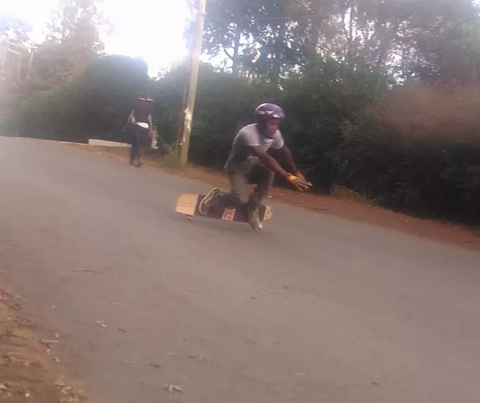 A skater with road rash on their arm, highlighting the physical realities of downhill skateboarding