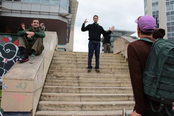 A slightly elevated view of a skater mid-trick in an urban area