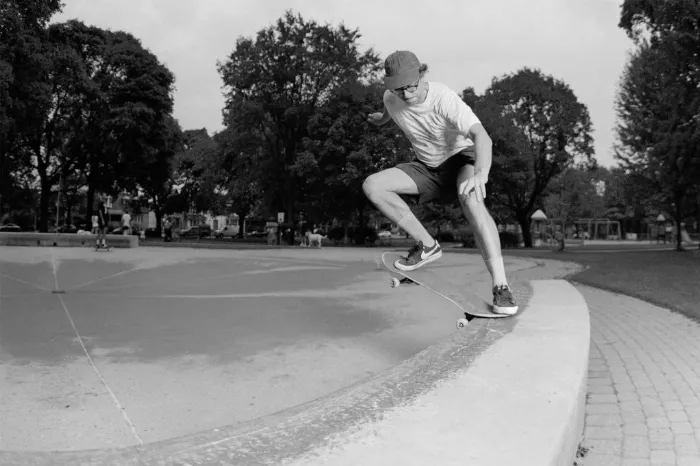 A still from &quot;Welcome to Hell&quot; showing a skater performing a trick with an urban background