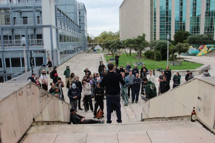 A wide shot of a skater performing a trick in a public space in Bordeaux