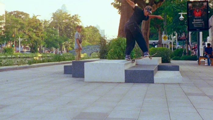 A wide shot of Ronnie Kessner skating, showing the urban landscape