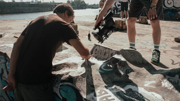 A wide shot of the DIY fingerboard park, showcasing the various concrete obstacles and ramps.