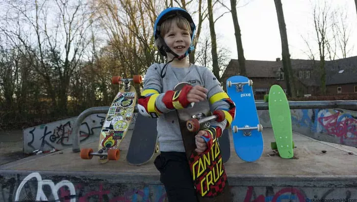 A young child carefully holding a longboard, showcasing the proper way to handle the equipment.