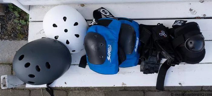 Adult wearing full protective longboarding gear, including helmet, elbow, and knee pads