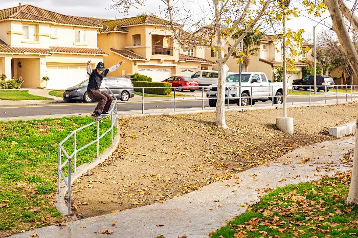 Aidan Campbell performing a frontside 50-50 grind on a rail