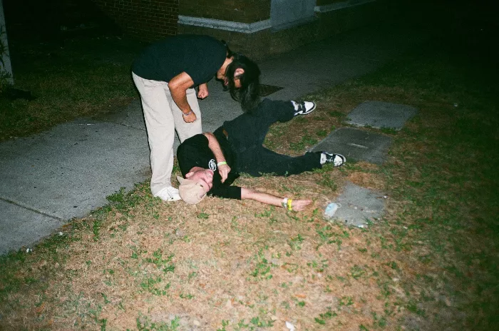 Alexis and Tristan engaged in friendly sidewalk wrestling