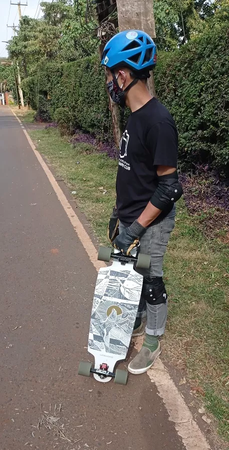 An adult longboarder enjoying a ride on a Landyachtz Drop Cat 33