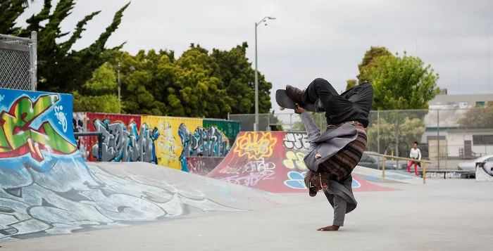 Avery Baxter performing a streetplant in a suit