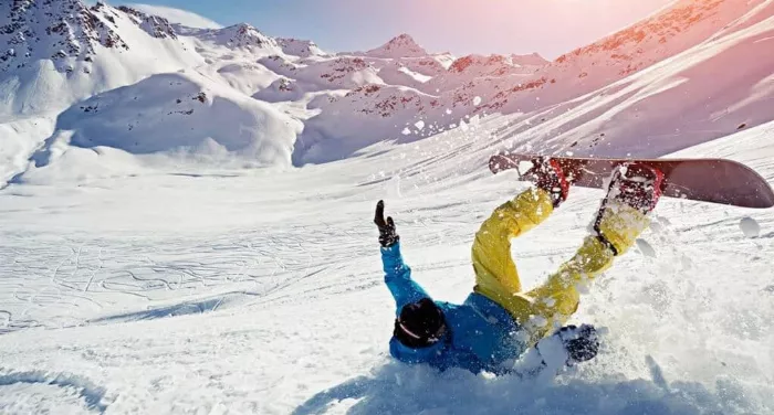 Beginner snowboarder crashing on the snow