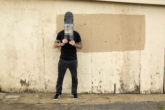 Bill Weiss, founder of Opera Skateboards, stands in front of a skate ramp.