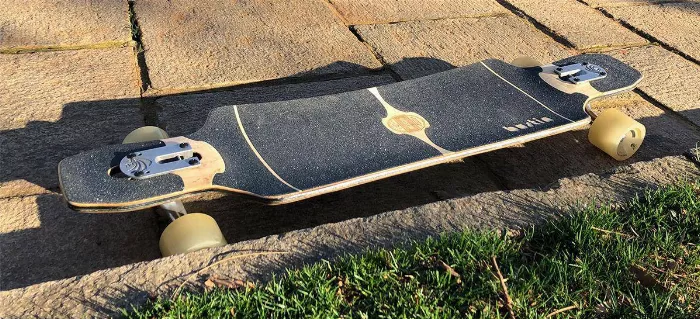 Bustin Maestro longboard on rough pavement