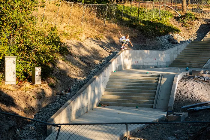 Caden Smith performs a backside 5050 grind on a ledge, showcasing his technical skill