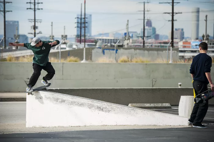 Chewy Cannon performing a switch frontside boardslide transfer