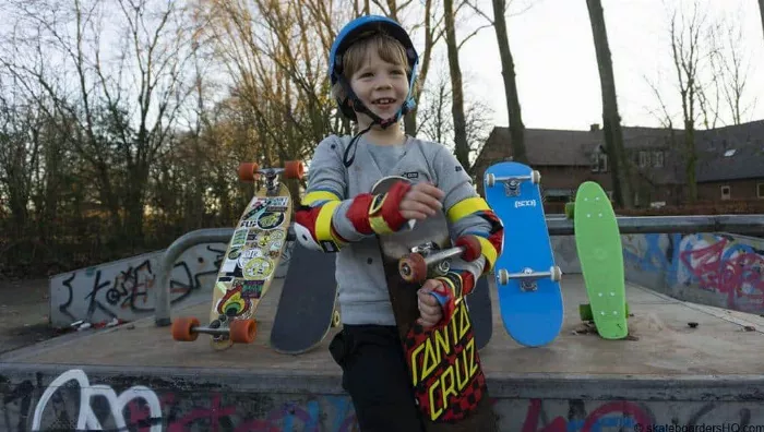 child holding a skateboard