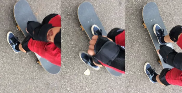 Child learning to push on a longboard