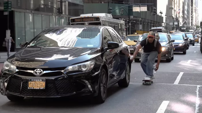 Christian Henry attempting a trick at a Midtown skate spot