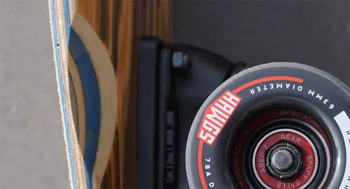 Close-up of wheel wells on a longboard deck