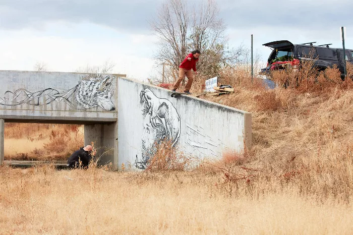 Donnie Mortensen performing a boardslide on a dirt bank with his off-road skateboard